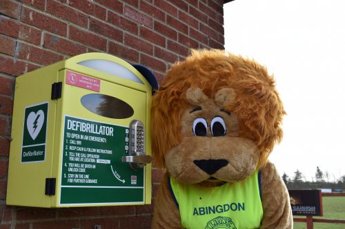 Alex the Lion with one of the Abingdon Lion defibrillators